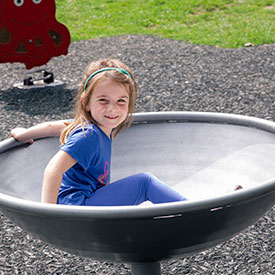 Girl on a hemisphere shaped rotating equipment 